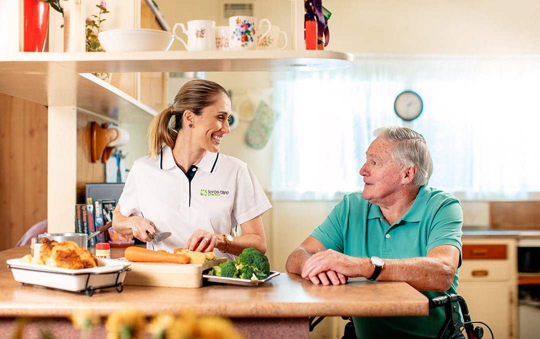 Community service worker preparing meals with male client